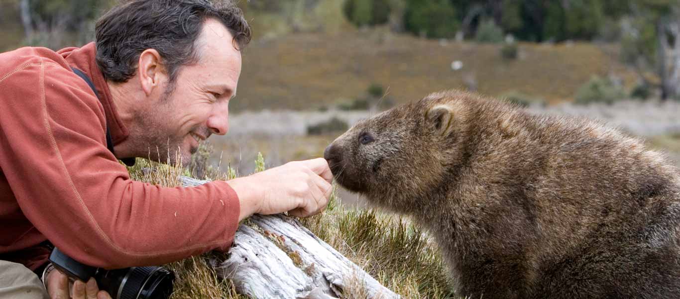 slide of expedition leader Jonathan Rossouw with a Tasmanian wombat at cradle mountain national park