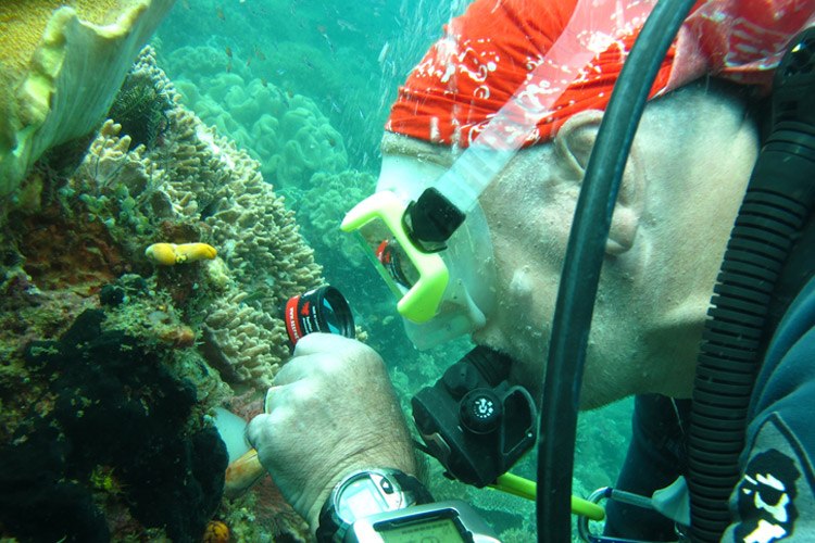 Photo of scuba diver with magnifying glass
