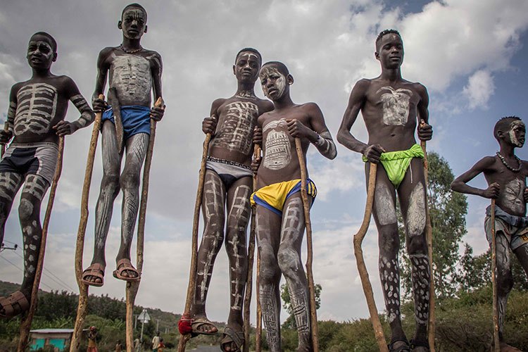 Ethiopia holidays photo of south omo boys stilt walking