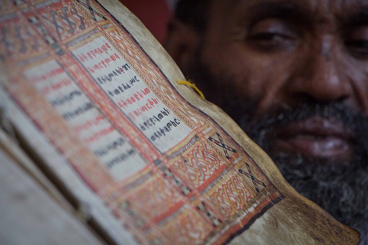 Ethiopian culture tour photo of lalibela priest holding scroll