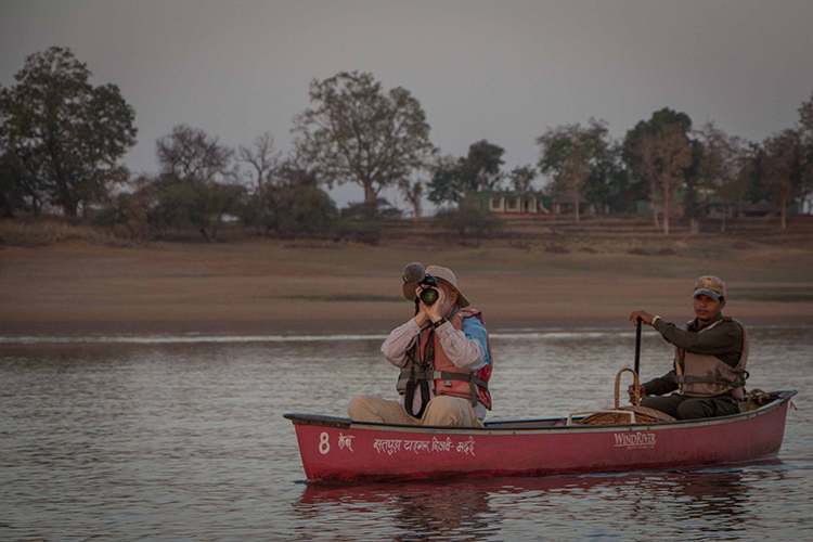India wildlife safari traveler in boat on denwa river satpura