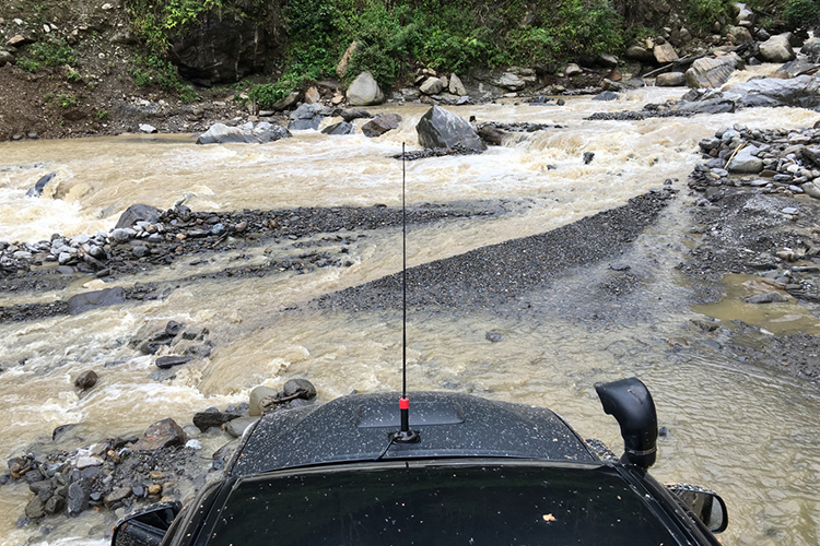 Vehicle crossing river on Vogelkop Peninsula in western New Guinea on 9000 bird quest